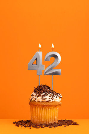 Number 42 candle - Birthday card design in orange background. cupcakeの写真素材
