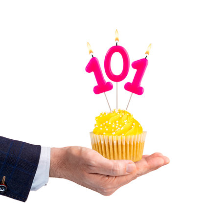 Hand holding a cupcake with a number 101 candle - Birthday on a white backgroundの写真素材