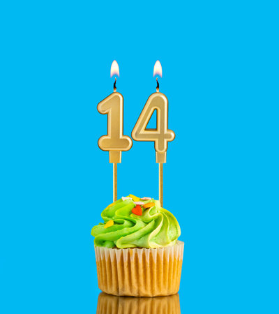 Candle number 14 - Birthday card with cupcake on blue backgroundの写真素材
