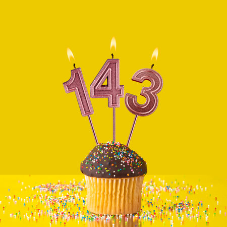 Candles forming the number 143 - Yellow background.の写真素材