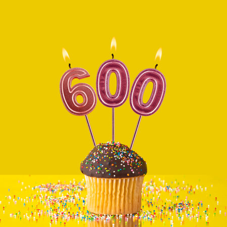 Candles forming the number 600 - Yellow background.の写真素材