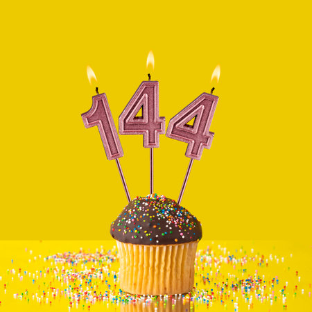 Violet candles forming the number 144.の写真素材