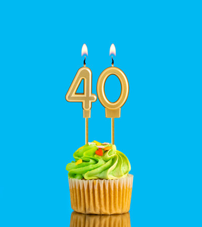 Birthday cupcake with candle number 40 - Blue background