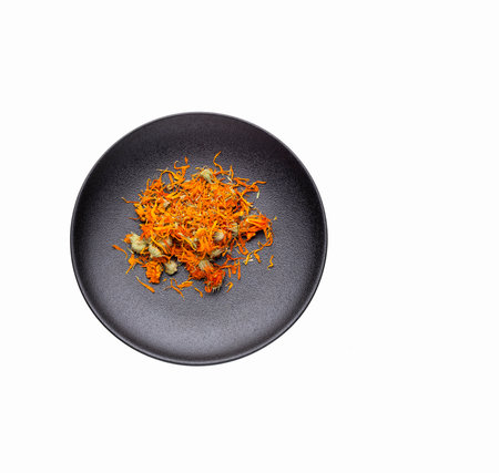 Calendula officinalis - Organic calendula petals in a dark bowlの写真素材