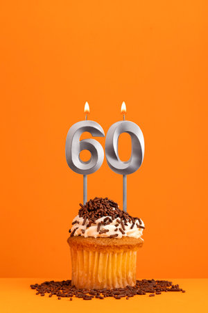 Number 60 candle - Birthday card design in orange background. cupcakeの写真素材