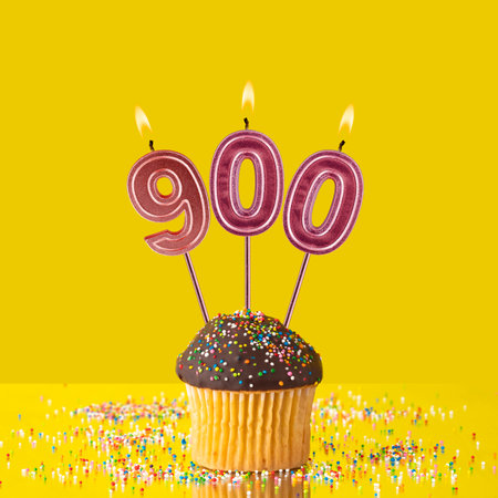 Candles forming the number 900 - Yellow background.の写真素材