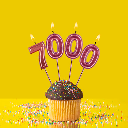 Candles forming the number 7000 - Yellow background.の写真素材