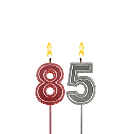 Lit birthday candle - Candle number 85 on white background