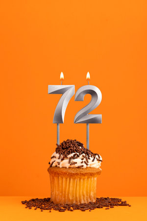 Number 72 candle - Birthday card design in orange background. cupcakeの写真素材