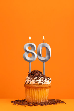Number 80 candle - Birthday card design in orange background. cupcake