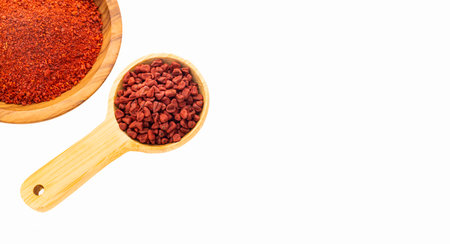 Red annatto seeds in spoon and bowl - Bixa Orellanaの写真素材