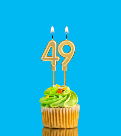 Candle number 49 - Birthday card with cupcake on blue backgroundの写真素材