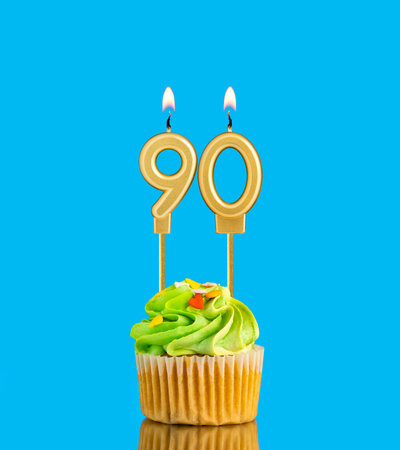 Birthday cupcake with candle number 90 - Blue background