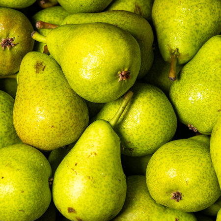 Pears for sale in a traditional Colombian market, highlighting the color, texture, and freshness of...