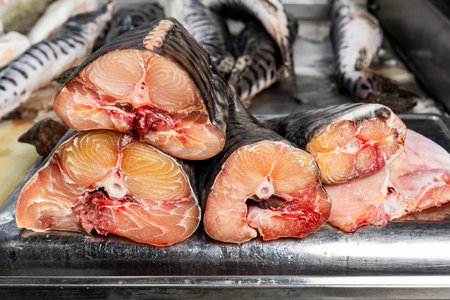 Catfish prepared for sale in a Colombian market, with visible cuts and an artisanal presentation...