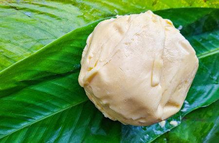 A ball of unprocessed organic butter on a bijao leaf, a symbol of healthy, traditional, and sustainable eating.の写真素材