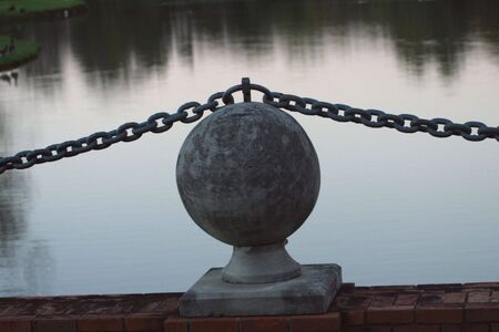 Ball on Chain Near Waterの写真素材