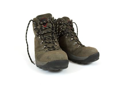 A pair of used hiking boots on white backgroundの写真素材