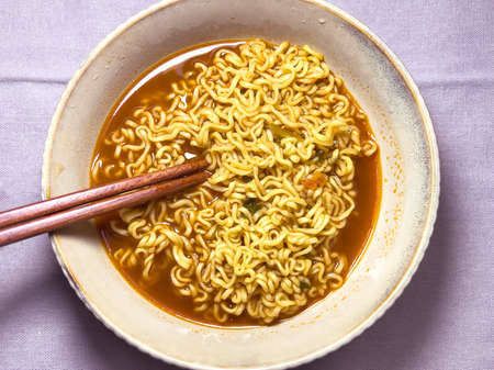 Spicy instant noodles cooked in water.の写真素材