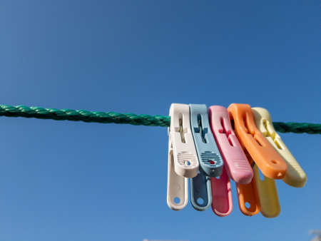 Close up of a colored clothespins on a clotheslineの写真素材