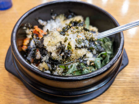 rice with fish eggs in steamed hot stone potの写真素材