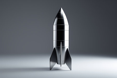Close-up picture of a silver rocket model on a gray backgroundの素材