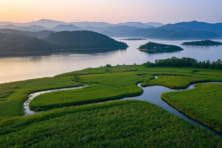 The peaceful twilight of the Wetland Park, where meandering rivers nourish the green wetlandsの素材