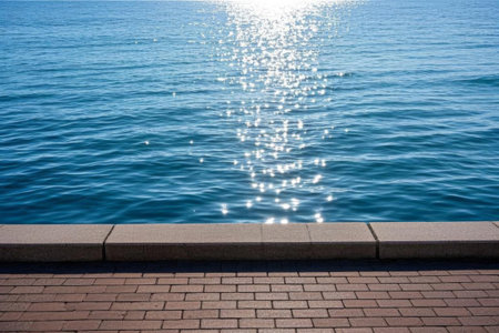 The sparkling waves of the sea, the sun shining on the calm seaの素材