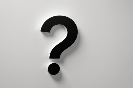 a close up of a black question mark on a white wallの素材