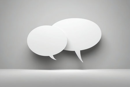 two white speech bubbles on a gray background with shadowの素材