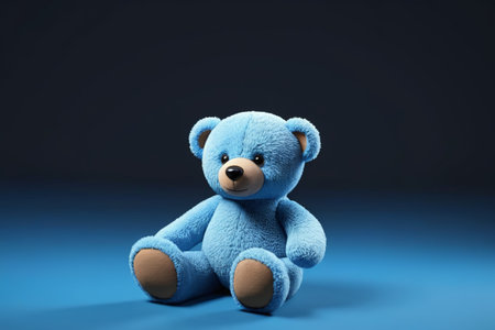 there is a blue teddy bear sitting on a blue surfaceの素材