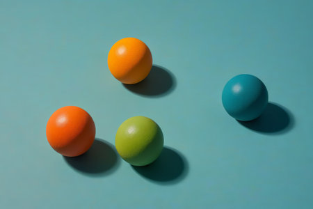 three balls of different colors are arranged on a blue surfaceの素材