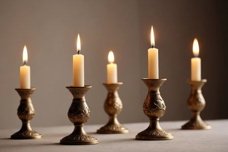 A quiet night with swaying candlelight, a warm glow on a golden candlestickの素材