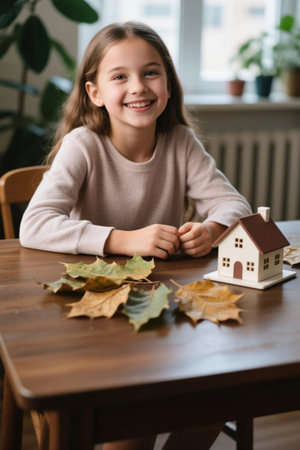 Girl smiling at mini house modelの素材