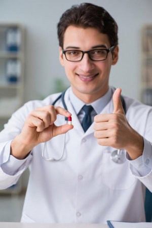 Doctor shows pills with thumbs upの素材