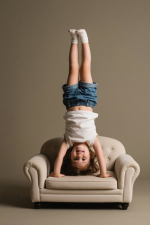 Cute girl doing handstands on the sofaの素材