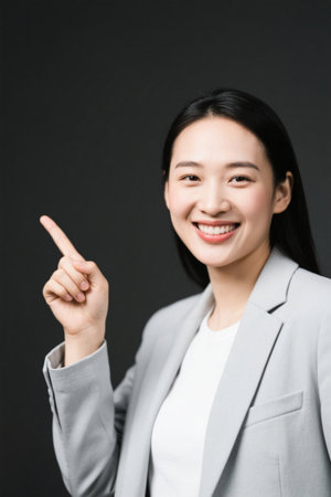 Smiling woman points the way to business eliteの素材