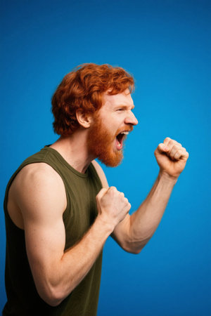 Red-haired man roars, punches and has an angry expressionの素材