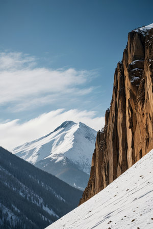 skiers on a steep mountain slope with a mountain in the backgroundの素材