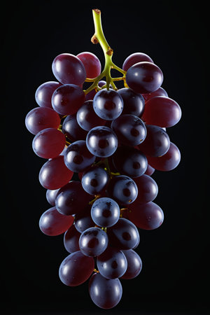 araffy photograph of a bunch of grapes on a black backgroundの素材