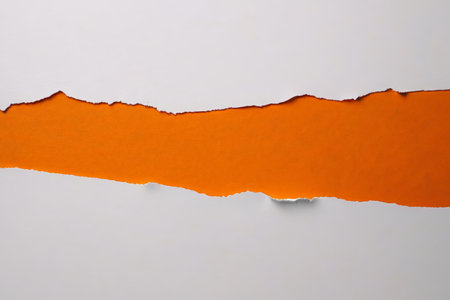 Tear open the white paper to reveal the orange backgroundの素材