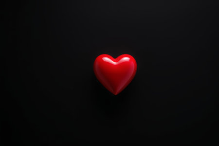 Red heart-shaped object on black backgroundの素材
