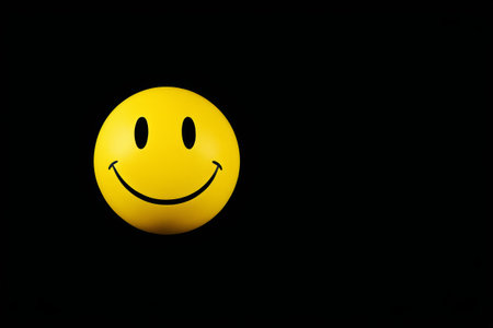 Yellow smile expression on black backgroundの素材