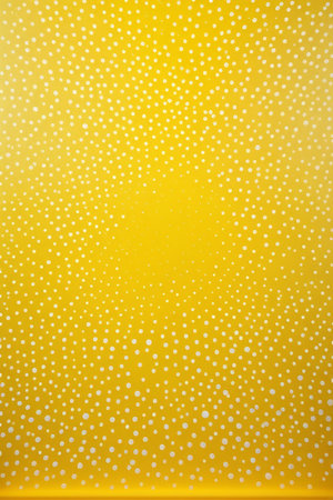 Yellow background with white polka dot patternの素材
