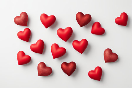 Red hearts scattered on a white backgroundの素材