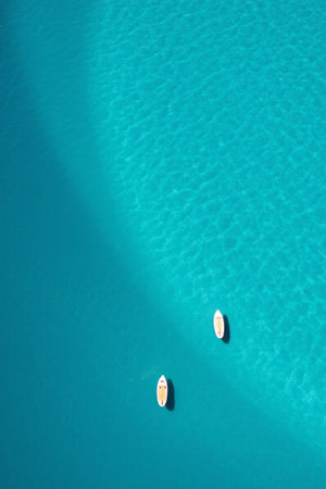 Aerial view of a small boat in the blue oceanの素材