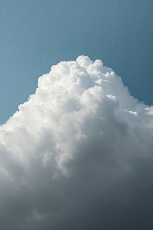 Fluffy cumulonimbus clouds in a blue skyの素材