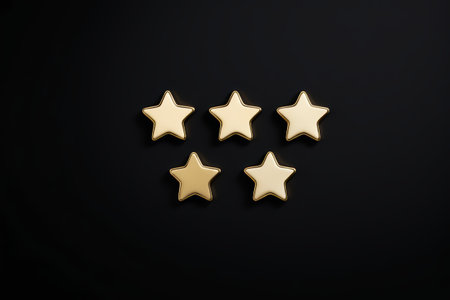 five gold stars are arranged in a row on a black backgroundの素材