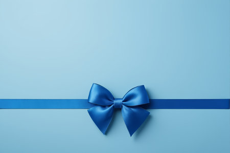 a close up of a blue ribbon with a bow on a blue backgroundの素材