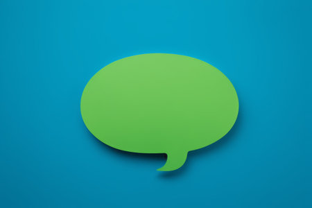 a close up of a green speech bubble on a blue backgroundの素材